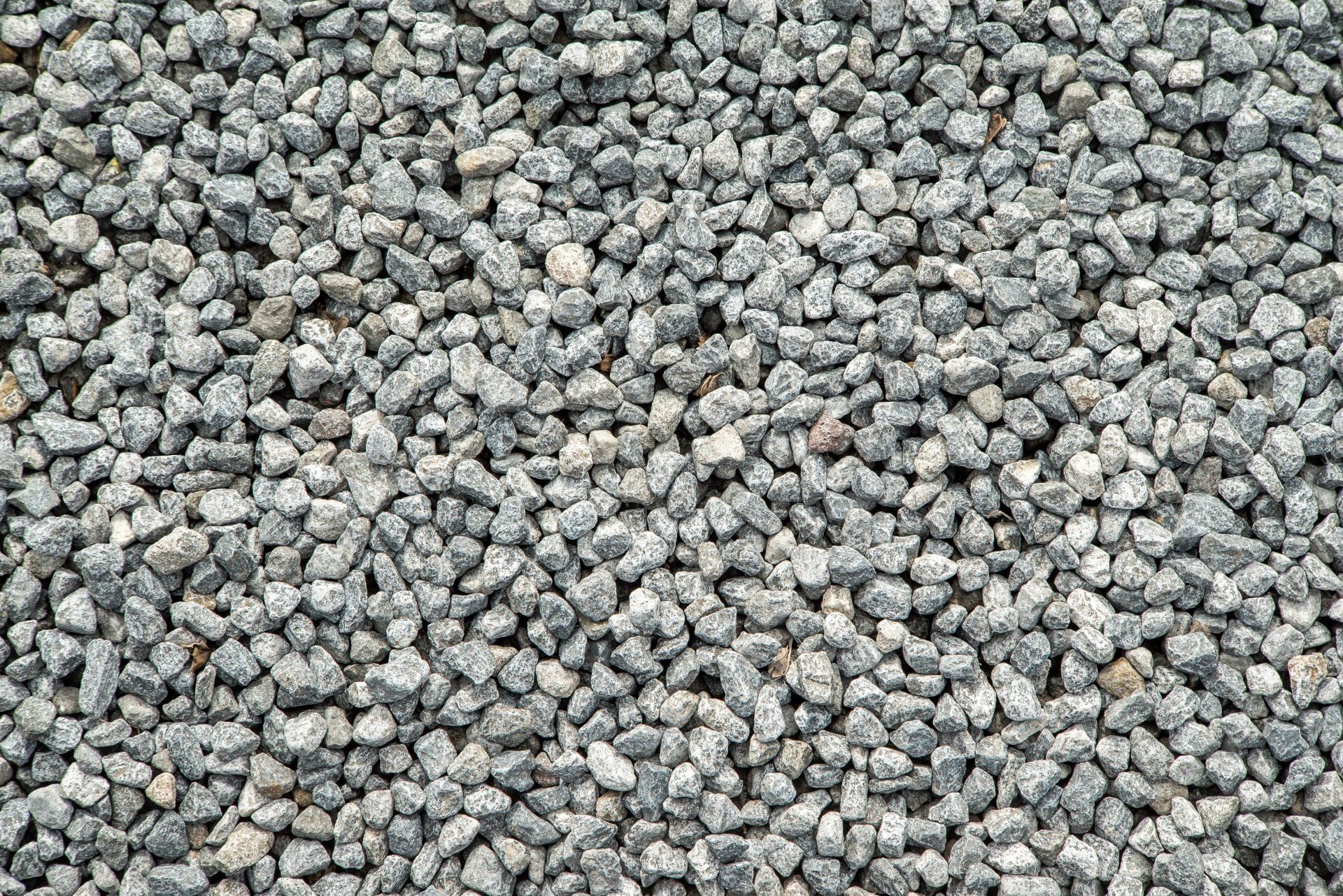 Close-up of a gray gravel surface with small, irregular stones